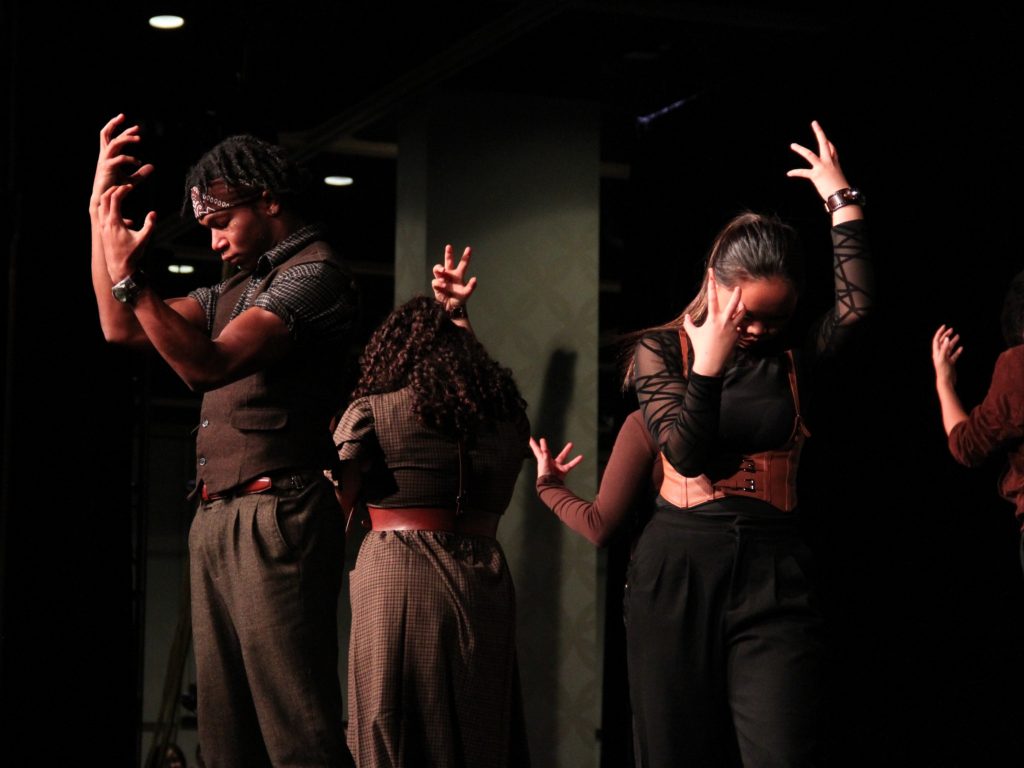Show choir students posing during a performance