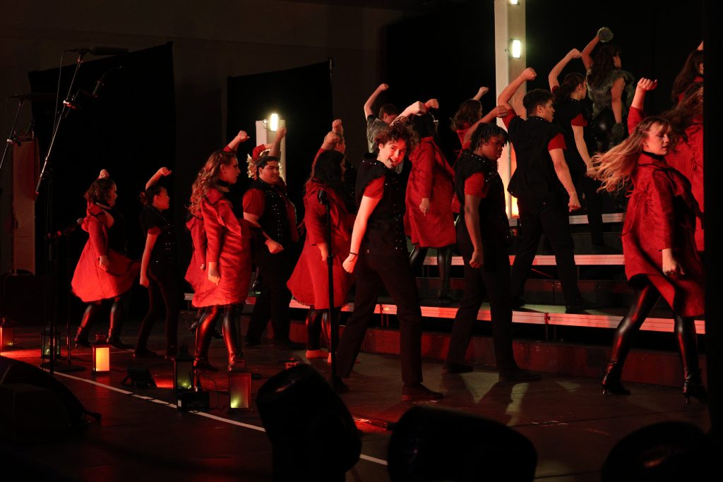 Syndicated Sound from Tarpon Springs High School performing in red jackets