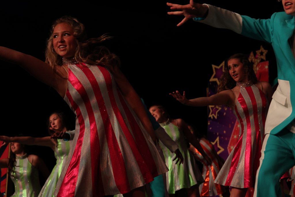 Radiance from Rosa Scott High School performing in striped costumes