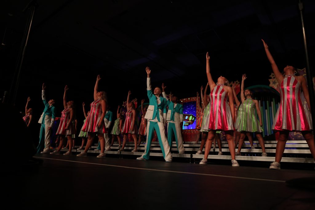 Radiance from Rosa Scott High School performing in striped costumes