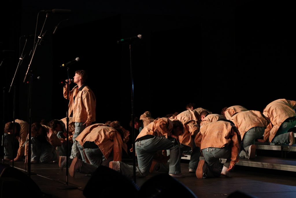 Mt. Zion High School's You've Got Male performing in orange jackets, baggy jeans and white baseball caps
